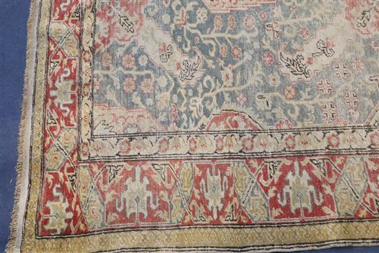 A Turkish blue ground rug, 6ft 5in by 4ft 5in.